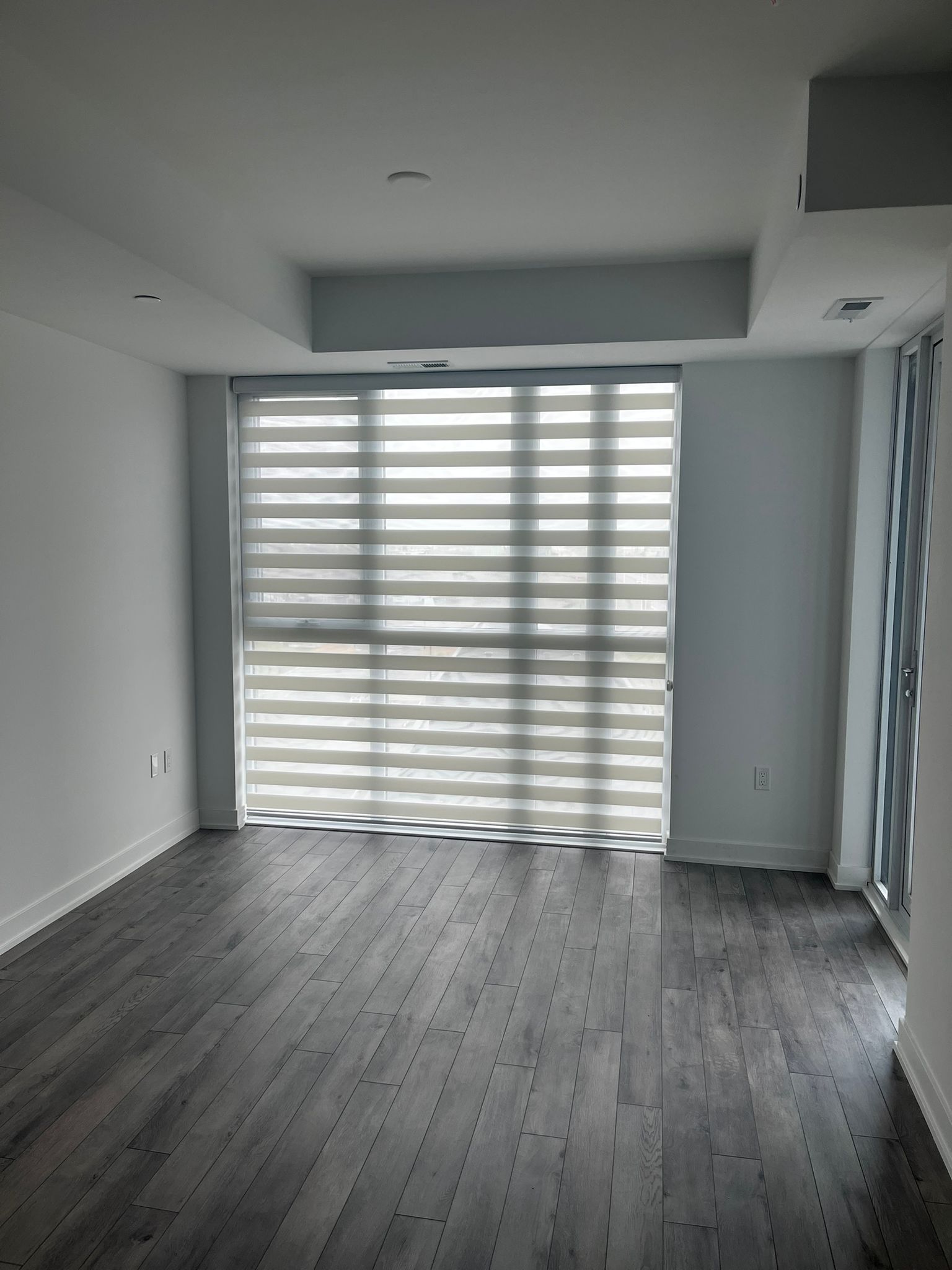 Completed room with custom zebra blinds filtering daylight